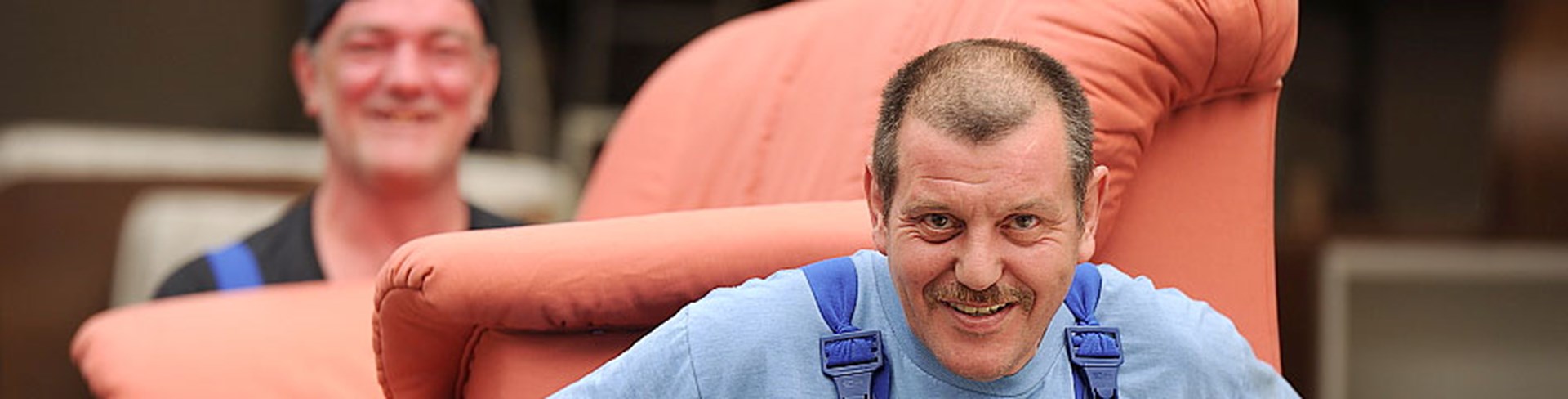 Zwei Männer schleppen ein Sofa