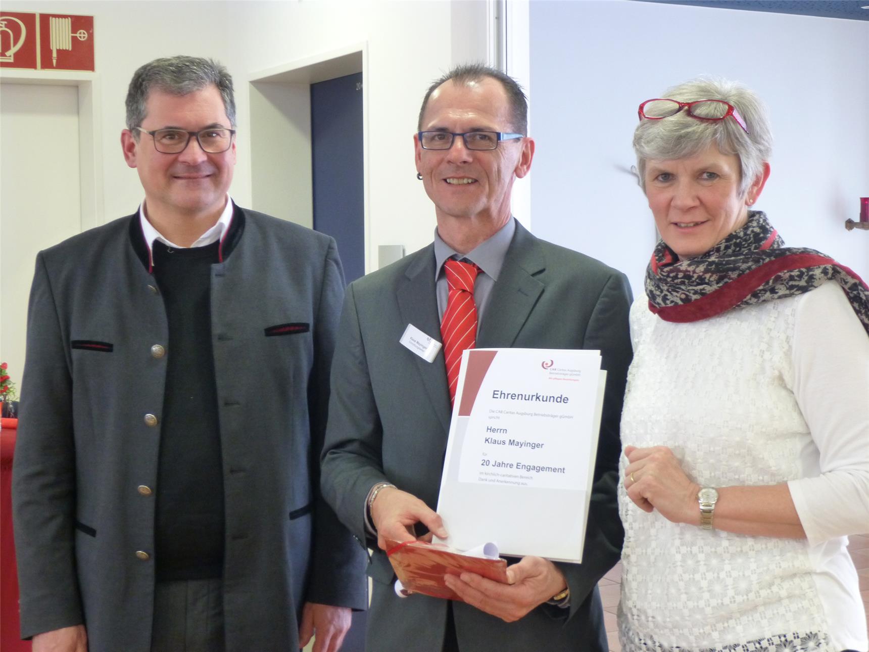 Ehrenurkunde für Einrichtungsleiter Klaus Mayinger von Caritasdirektor Dr. Andreas Magg und CAB-Geschäftsführerin Brigitta Hofmann.