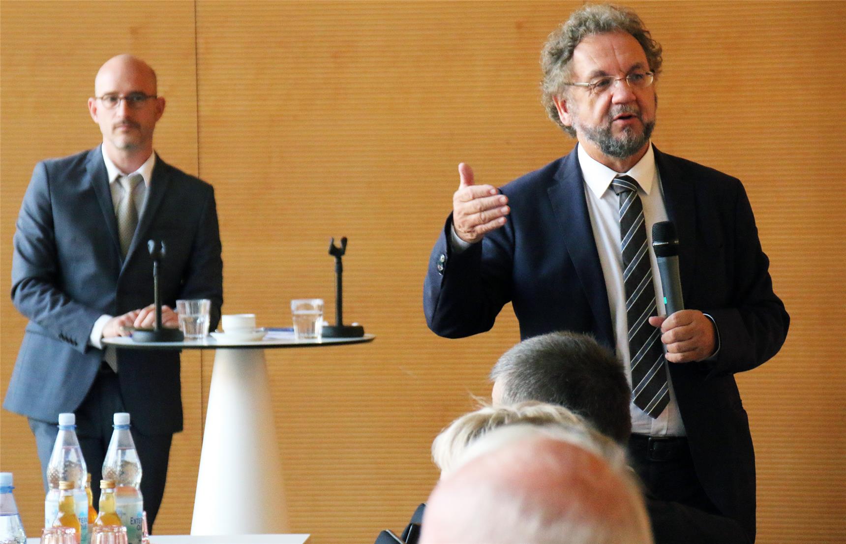 Das Foto zeigt einen Redner gestikulierend vor einer Menschenmenge.