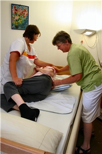 010-2022 Impfpflicht Das Foto zeigt zwei Pflegerinnen, die einen alten Mensch im Bett umdrehen.