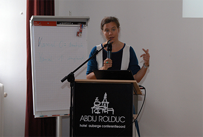 Prof. Dr. Chantal Munsch steht vor eine Rednerpult und hält einen Vortrag