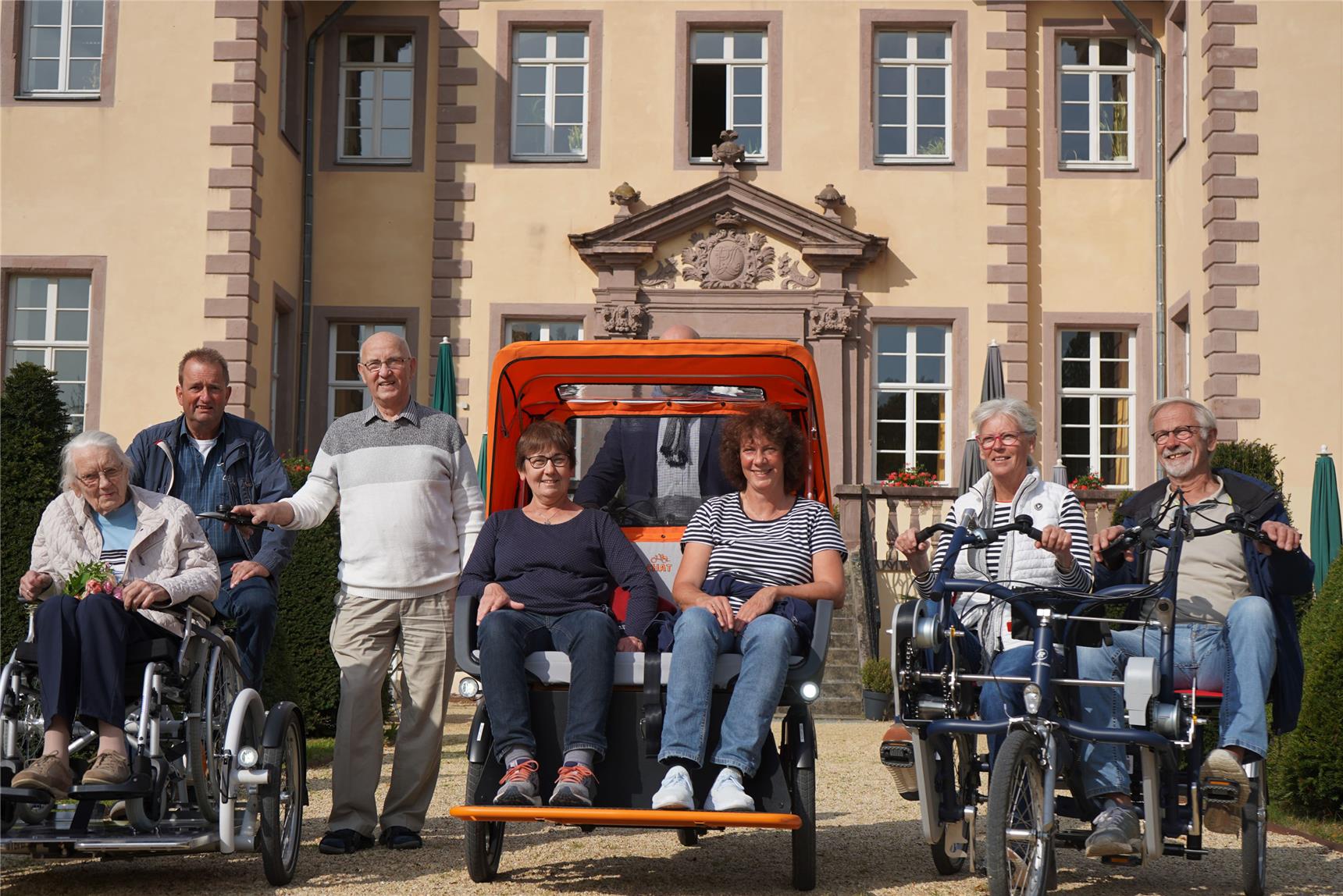 Vor dem Schloss Schieder präsentieren sich die Aktiven der Rikscha-Aktion mit „Testfahrerin der ersten Stunde“.