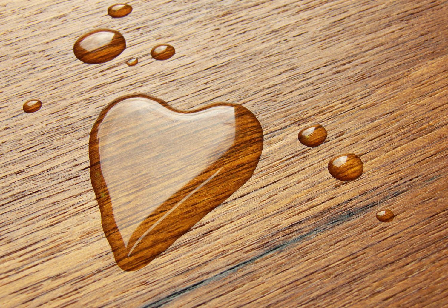 Hier wurde ein Herz mit Wasser auf eine Tischplatte gemalt.