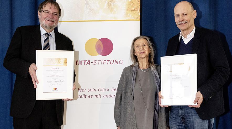 Zwei Männer mit Urkunden und eine Frau