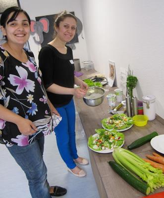 Zwei Mütter beim Salat machen